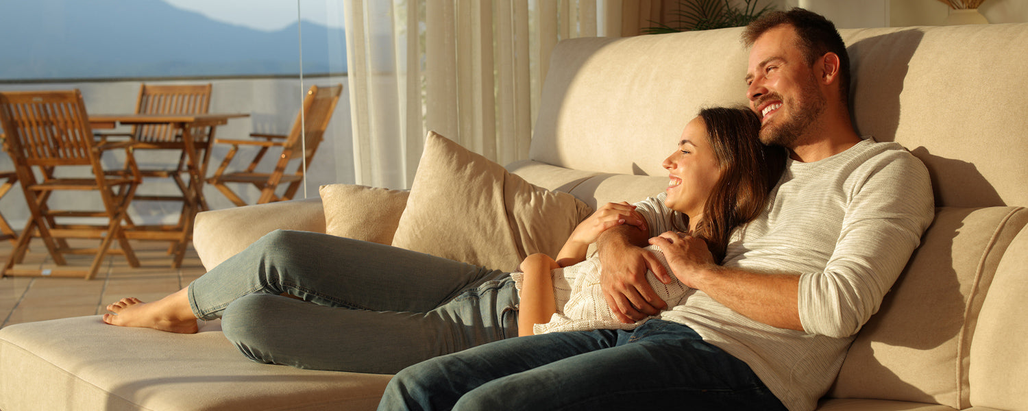 Happy couple relaxing on the couch enjoying a quiet moment together